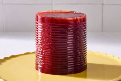 A canshaped cranberry sauce on a yellow plate