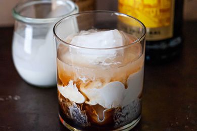 Swirling cream in a white russian cocktail