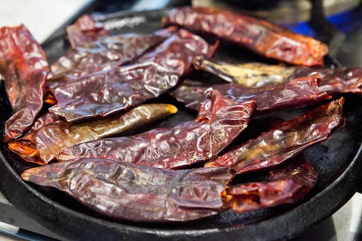 Roasted dried red chilies on a skillet