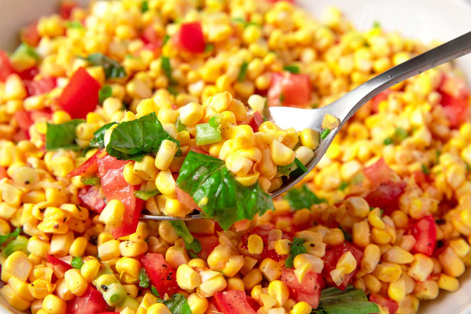 Corn salad with chopped tomatoes and herbs