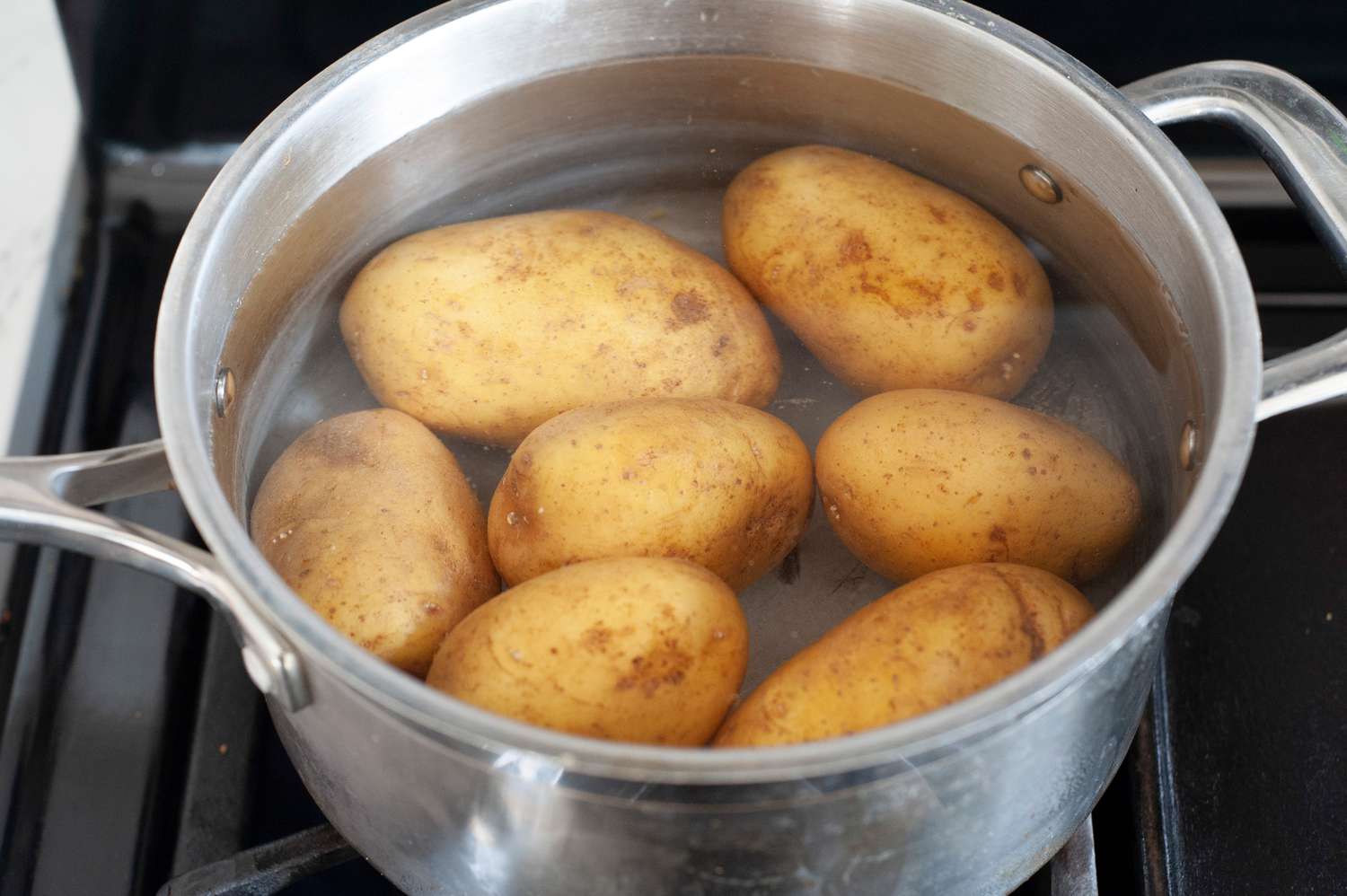 Pot of Water on Stove with Potatoes for Rosti Recipe