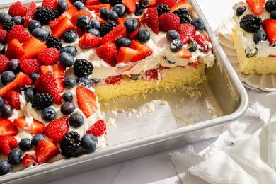 Easy Berry Chantilly Cake in tin, 2 slices removed and one set on a plate