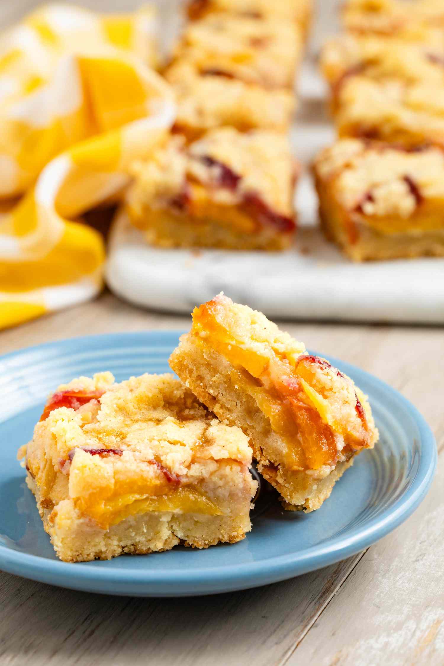 Peach pie bars stacked on a plate