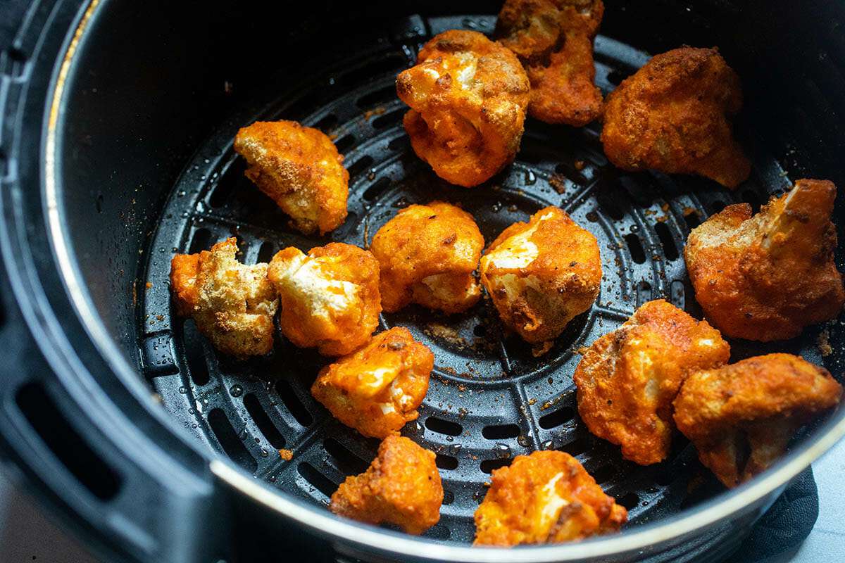 Air Fryer Cauliflower with Buffalo Sauce in an air fryer.