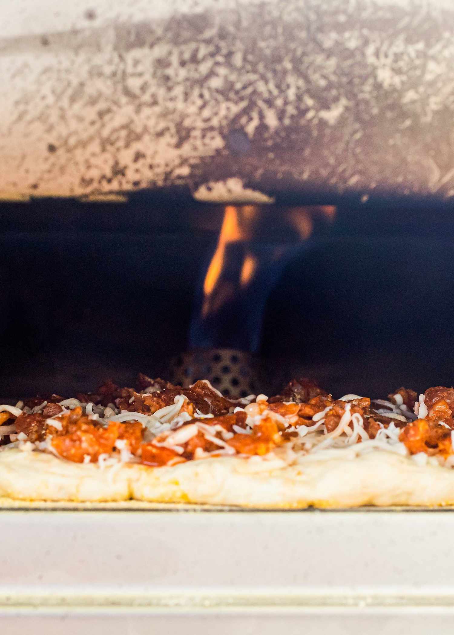 What is the Roccbox? This photo shows a pizza cooking inside with the fire visible.