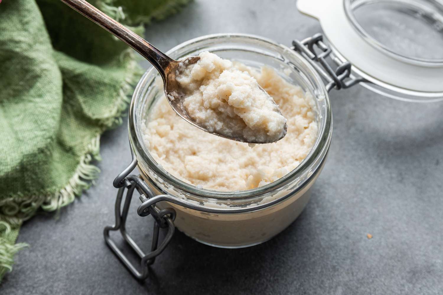 Overhead of a bowl of Homemade Prepared Horseradish with a spoon in it