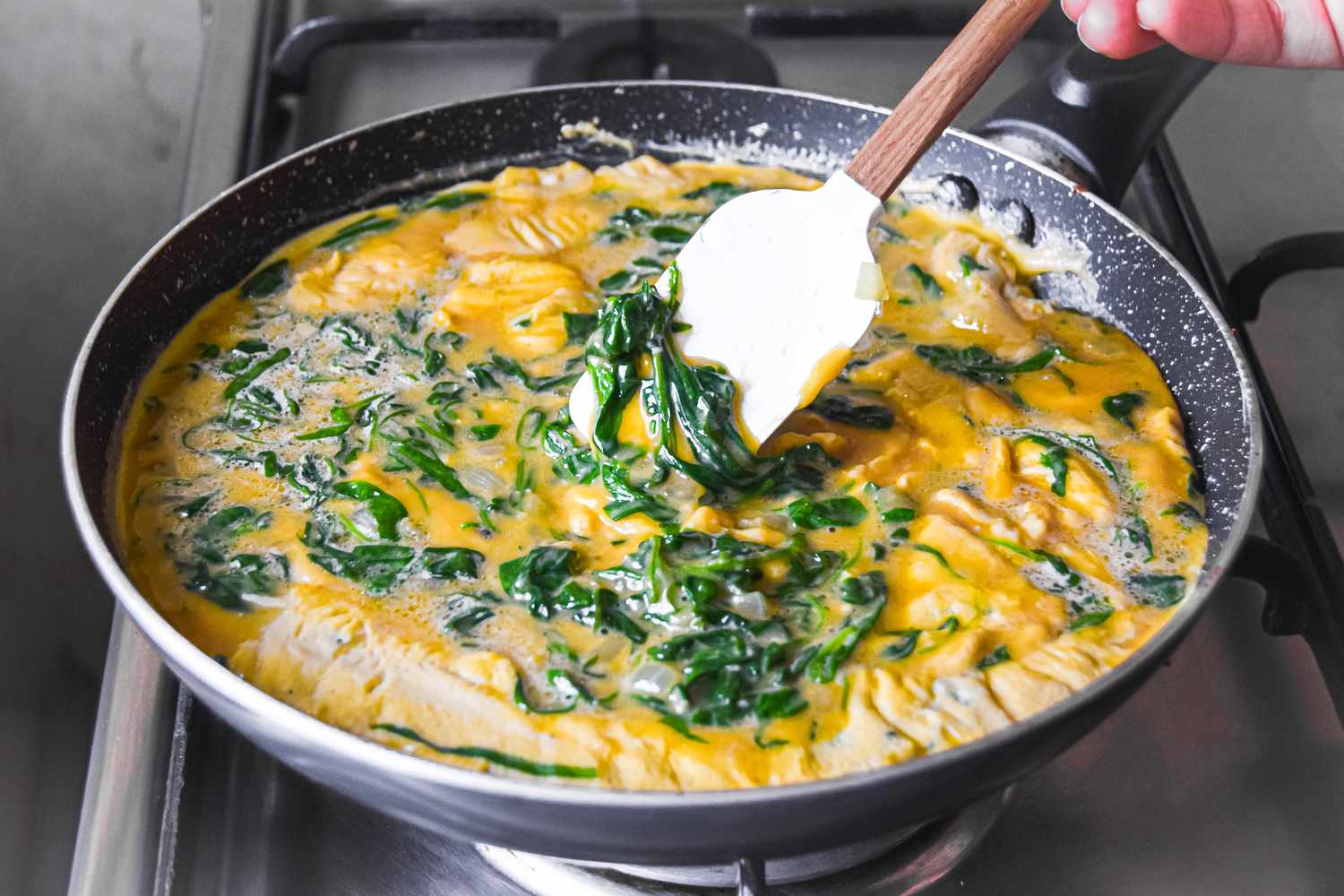 Stir Spinach Frittata Egg and Spinach Mixture in Pan