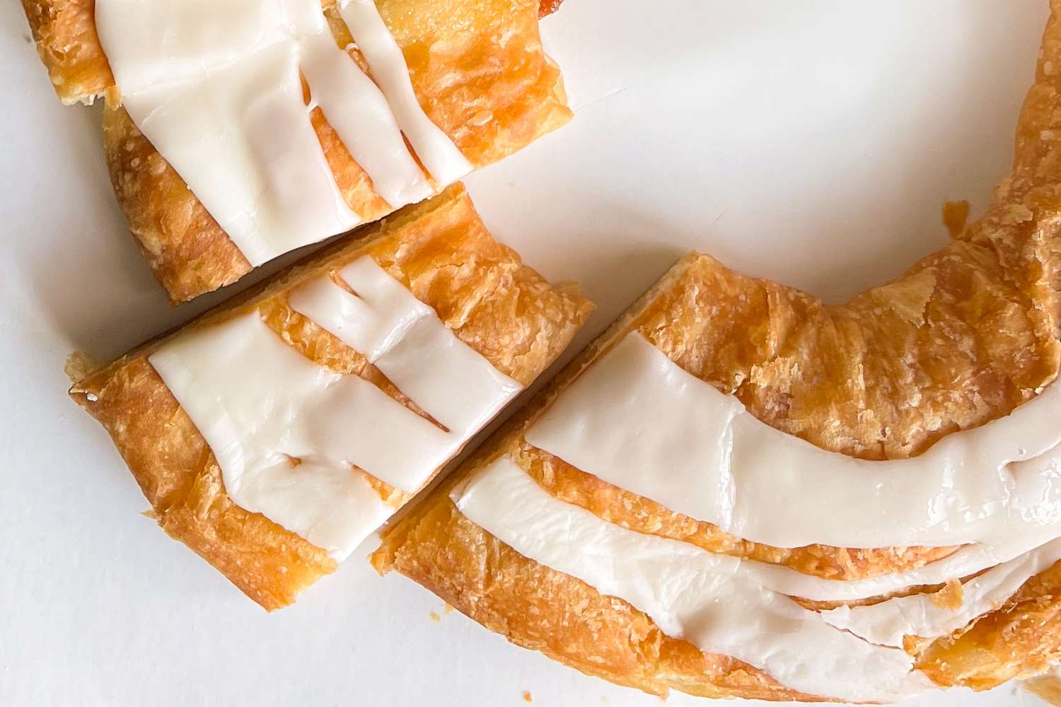 Close-up of a kringle pastry, showing the white icing on top