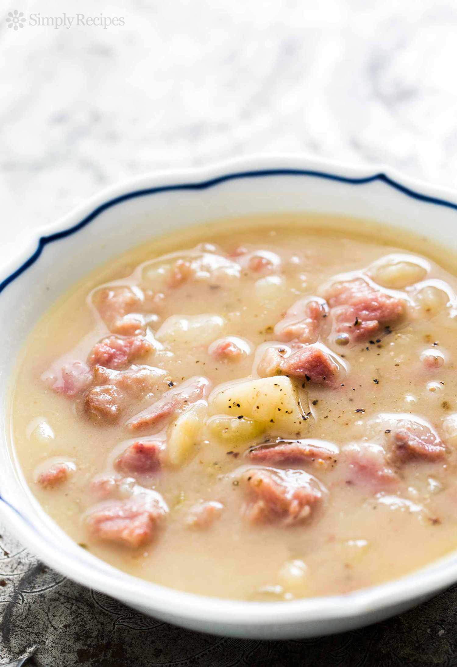 Potato and ham soup in a white bowl