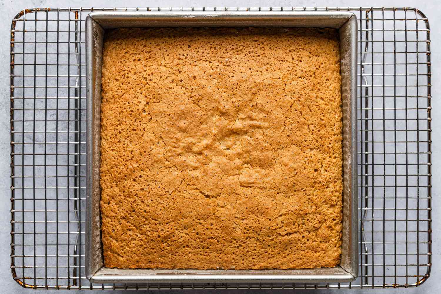 cake in square tin, cooling on a cooling rack - Feather Cake