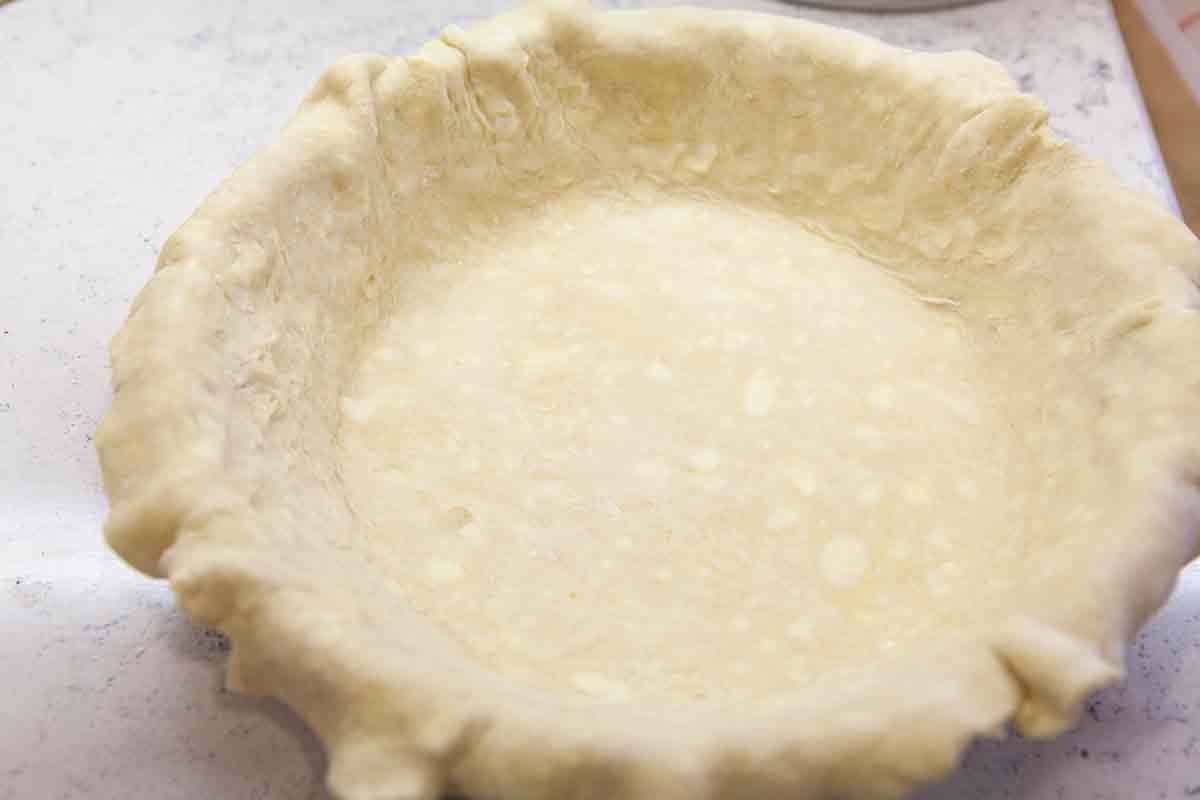 press rolled out dough into deep dish pie plate