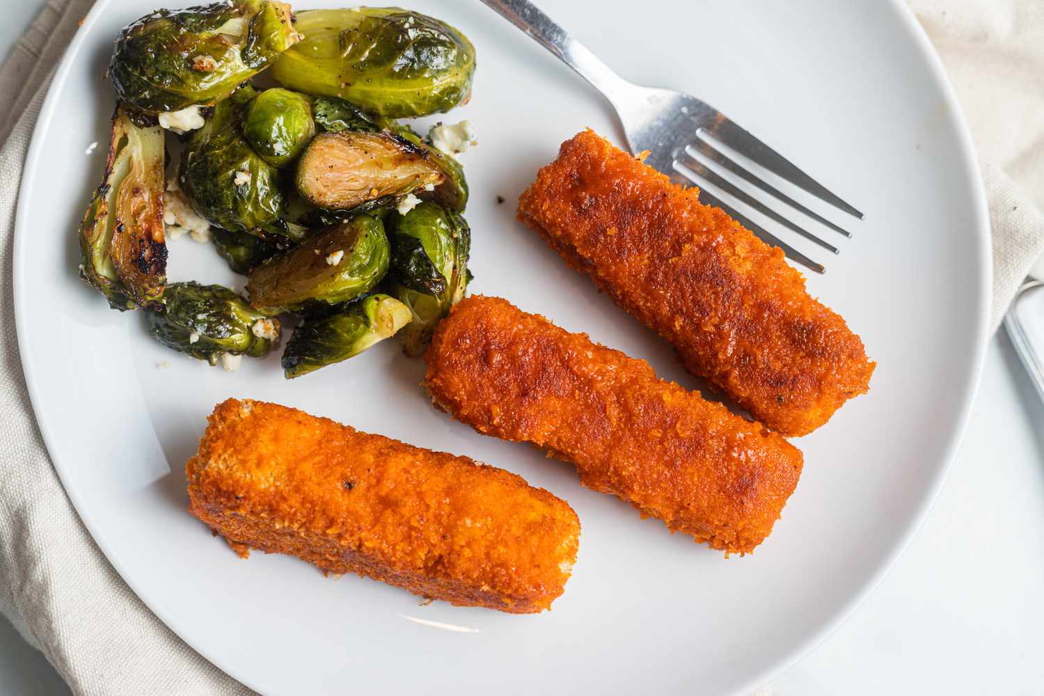 Sheet Pan Buffalo Tofu and Blue Cheese Brussels Sprouts on a Plate with a Fork