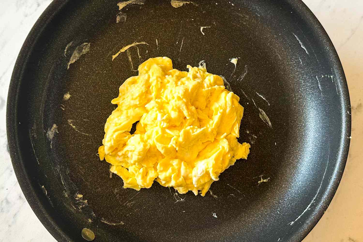 Scrambled eggs in a frying pan