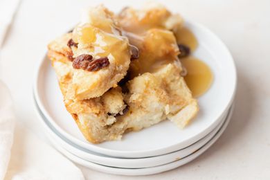 A stack of plates with easy bread pudding set on top.