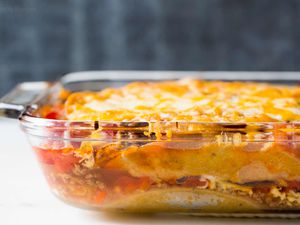 Mexican Lasagna made with tortillas, beef, beans, and cheese ready to serve