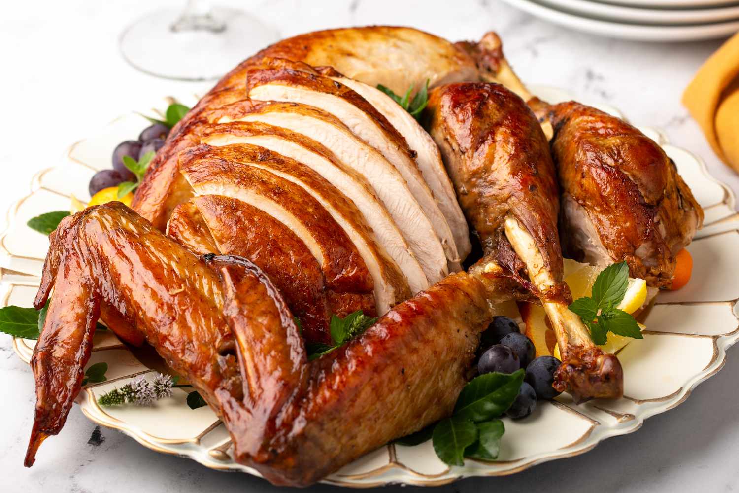 A well-browned turkey carved on a serving platter