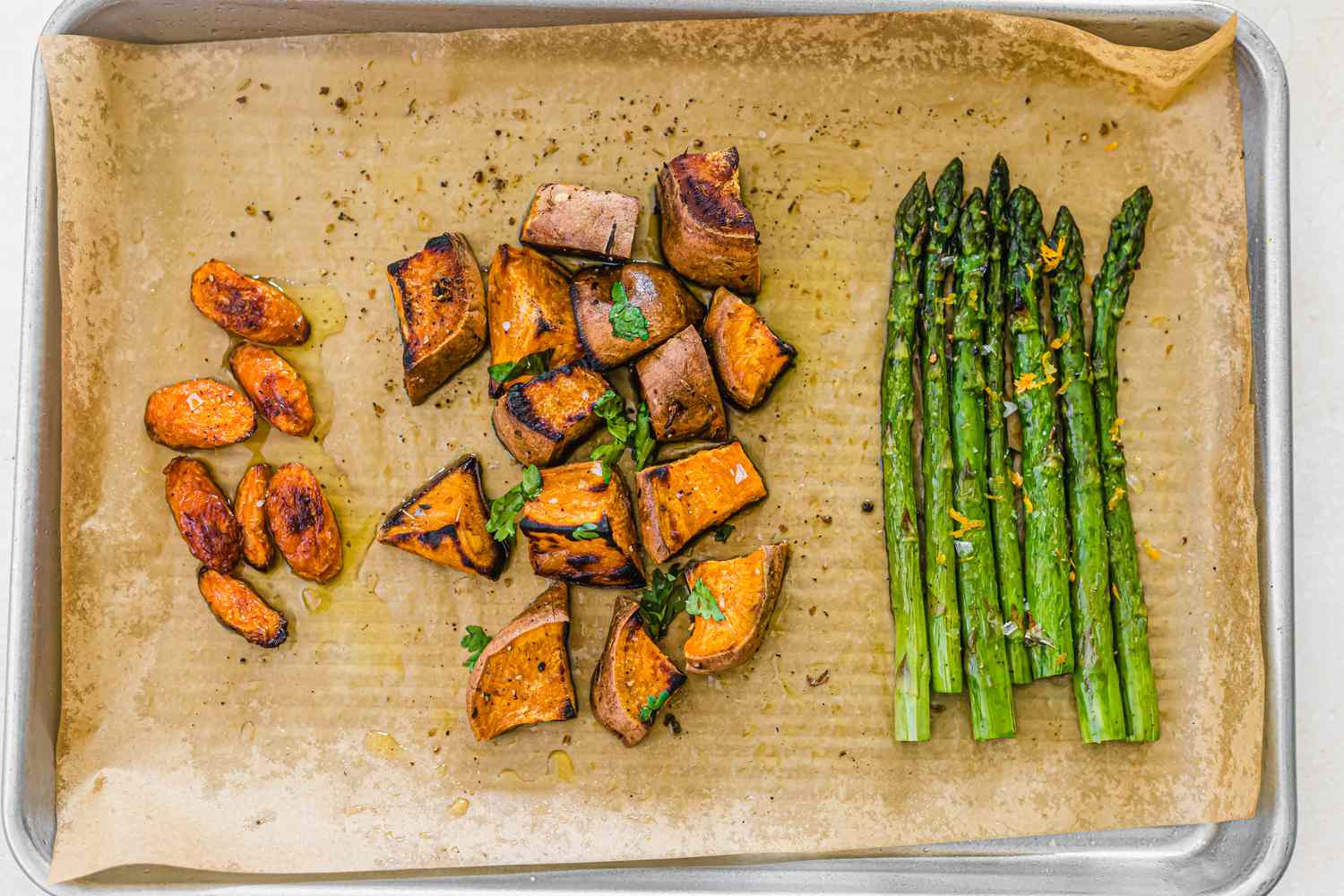 Roasted carrots sweet potatoes asparagus on a sheet pan
