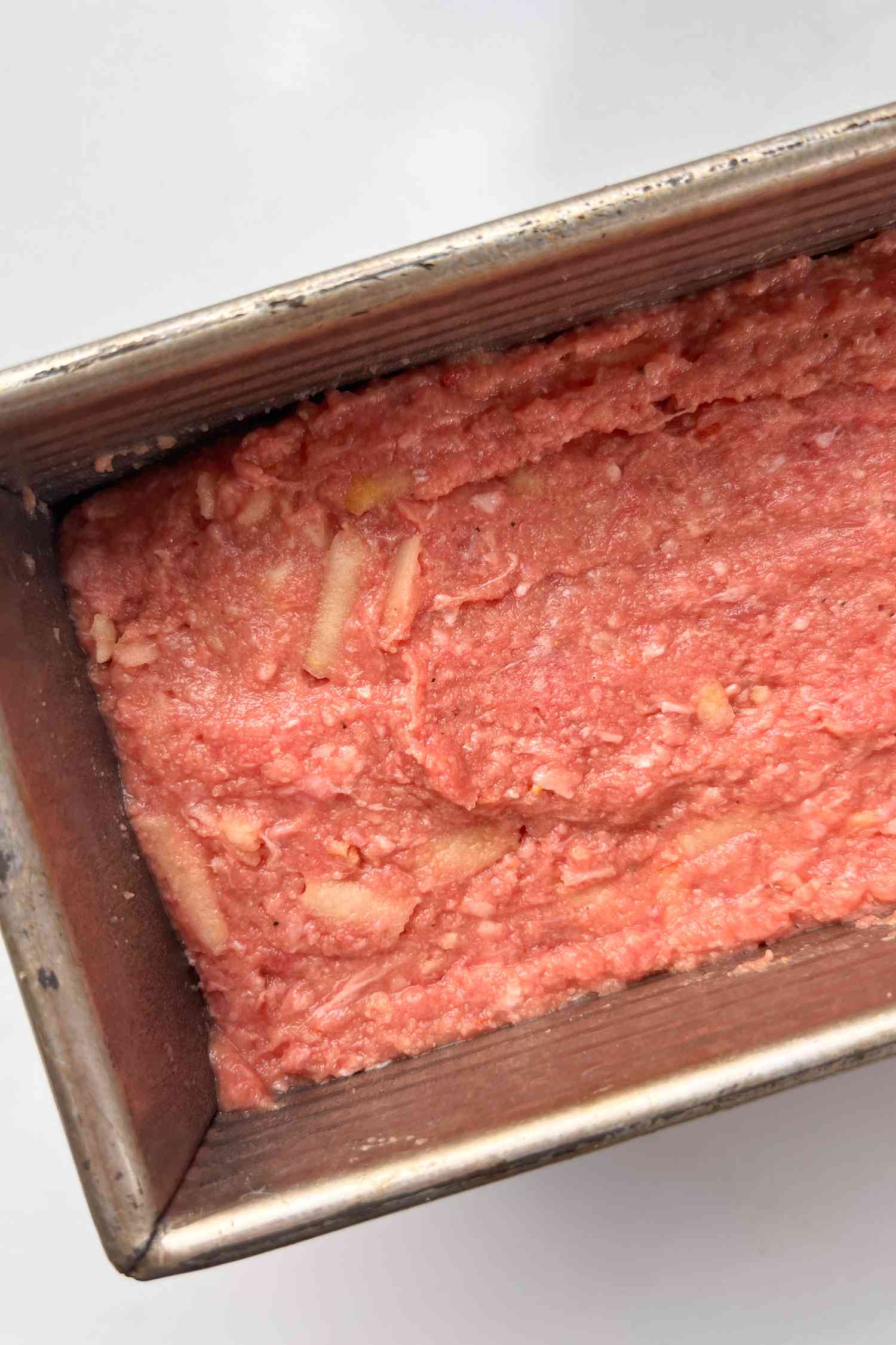 Grated apple visible in meatloaf mixture