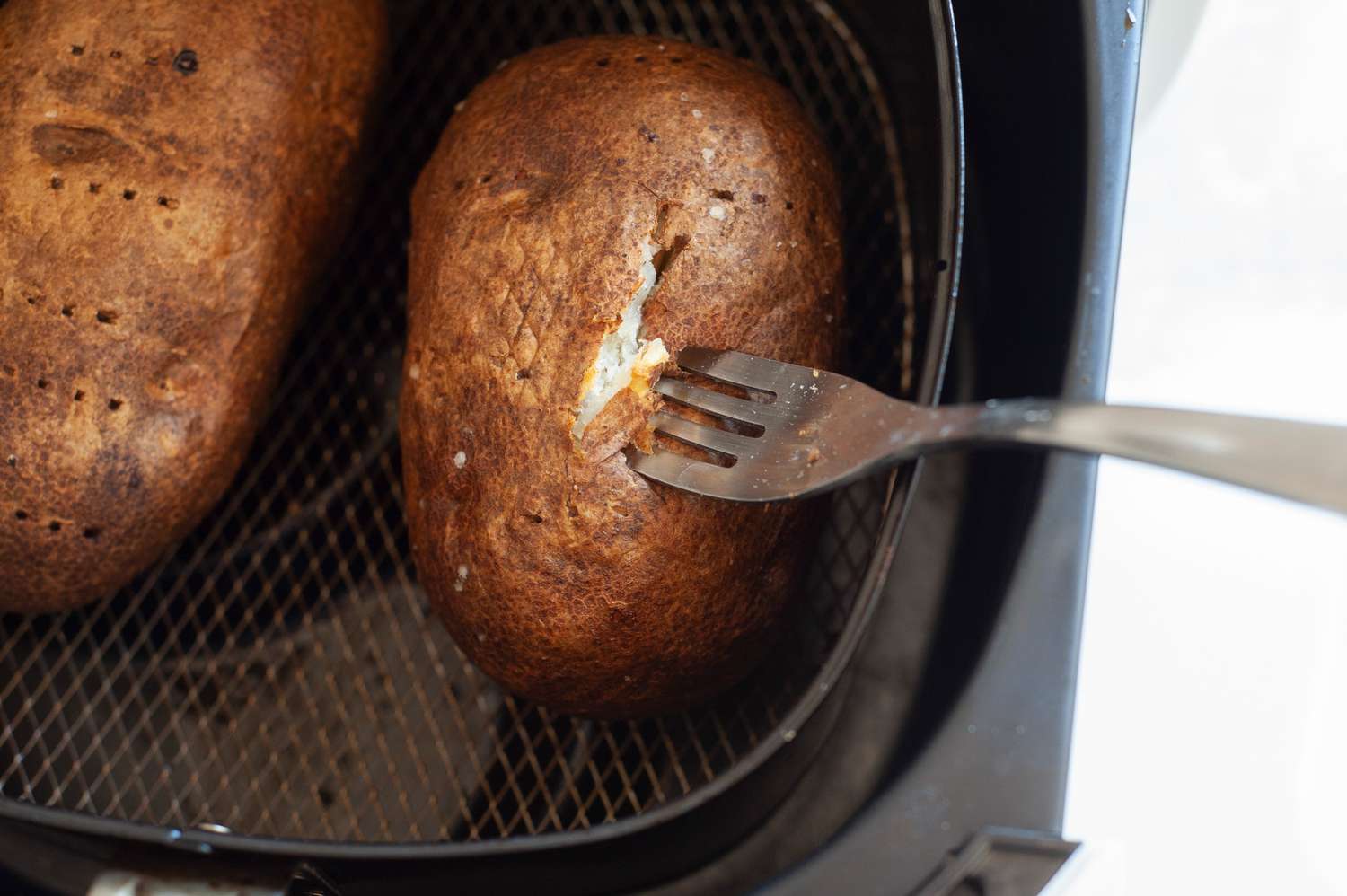 Air Fried Baked Potatoes Poked with a Fork