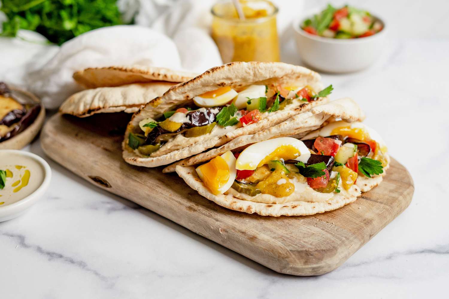 Sabich Sandwiches on a Wooden Plank
