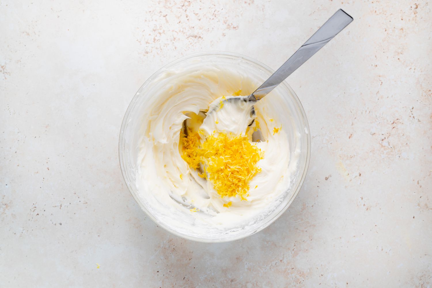 Adding lemon zest to buttercream for French macarons filled with lemon buttercream