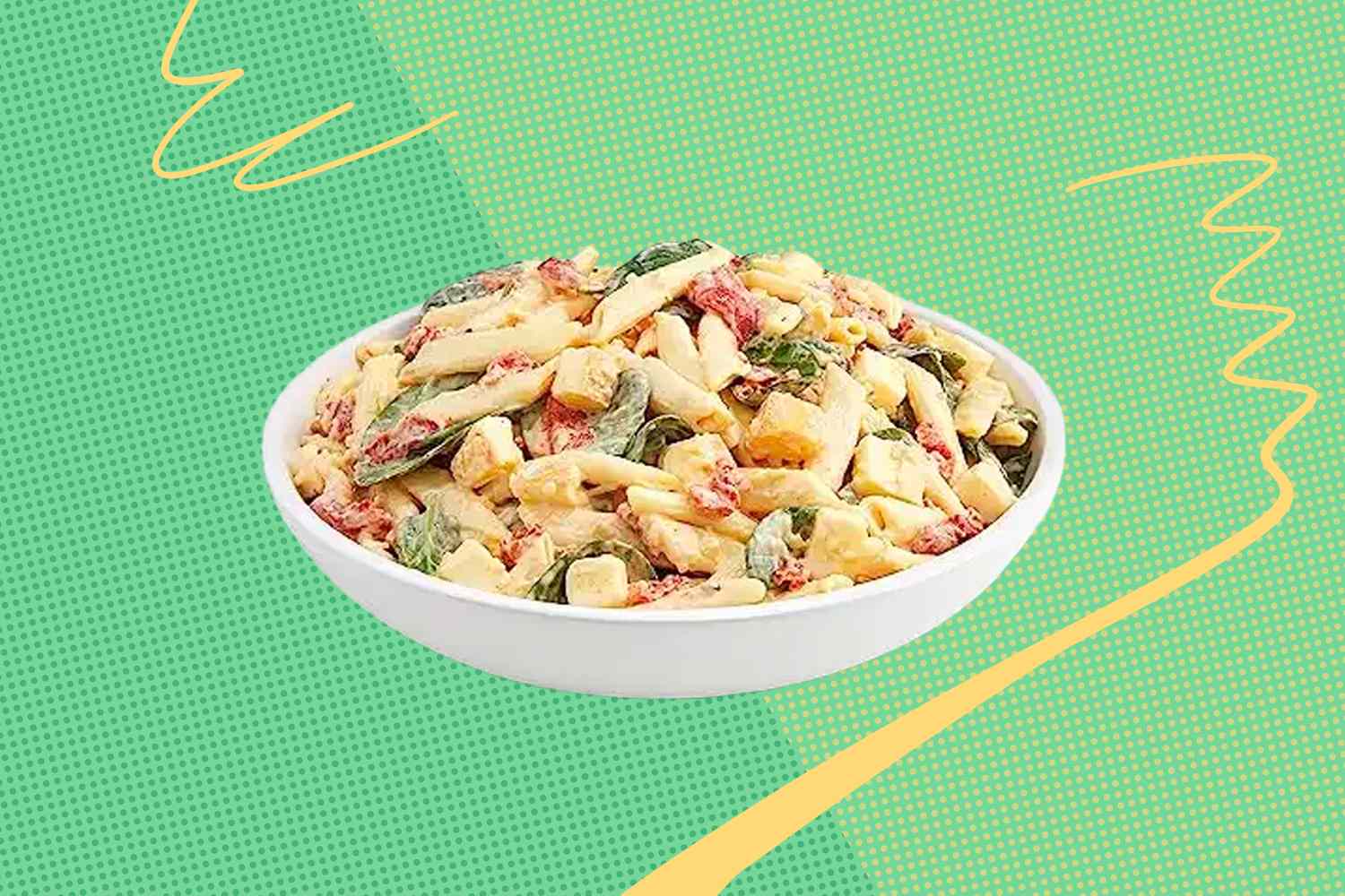 A bowl of pasta salad with various ingredients on a colorful background