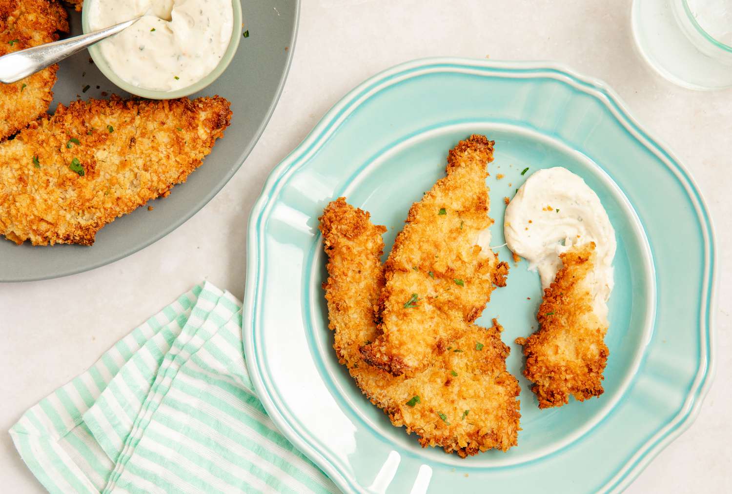 Air Fryer Chicken Tenders on a plate with ranch tip