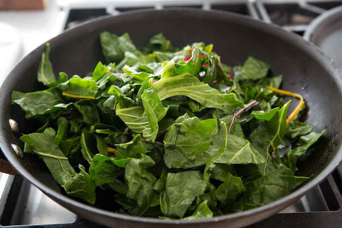 Swiss chard leaves cooking in a pan