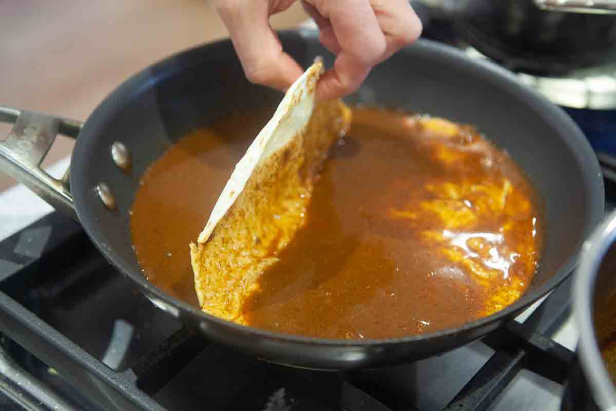 dip flour tortilla in enchilada sauce
