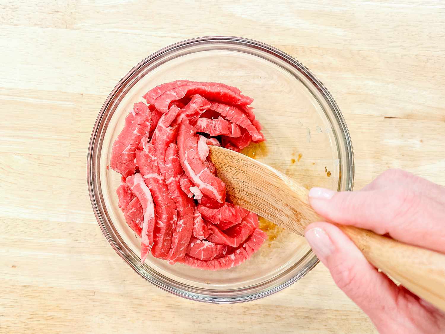 beef marinating in a bowl for japchae recipe
