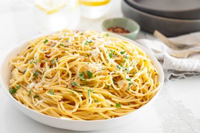 Spaghetti Aglio e Olio (Pasta With Garlic and Oil) Topped with Herbs and Parmesan