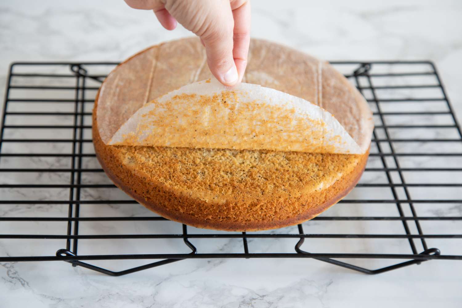 Peeling parchment paper off the bottom of the Earl Grey Tea Yogurt Cake.
