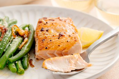 Plate of Salmon Filet with Brown Sugar Glaze and a Side of Green Beans. Some of Salmon Is on the Fork.