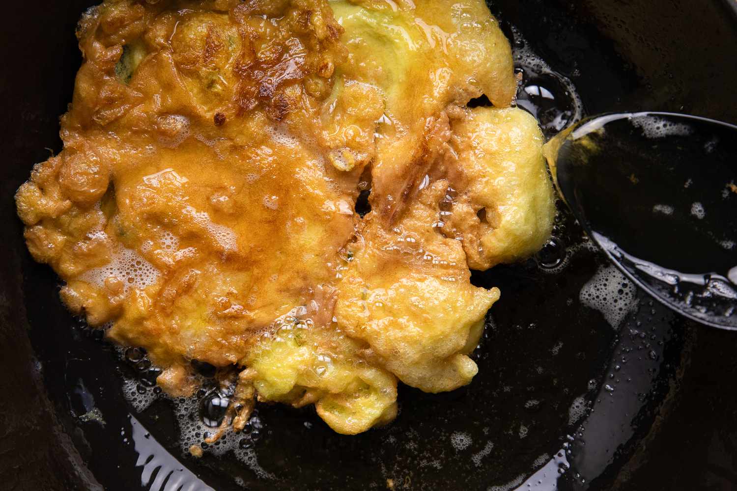 Hot Oil Spooned onto Egg Foo Young for More Color as It Cooks in the Wok