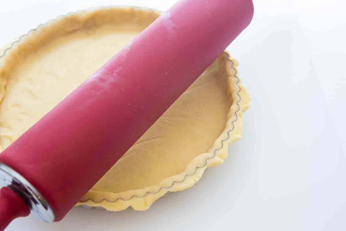 Clean edges of lemon tart crust by rolling over with rolling pin