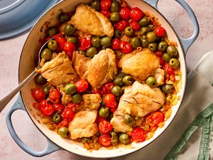 Overhead view of a blue dutch oven of tuscan-style chicken thighs recipe