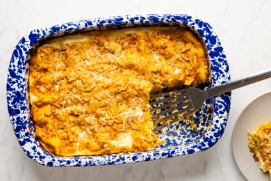 overhead view of Easy Pumpkin Lasagna in a casserole dish with a serving removed and a spatula