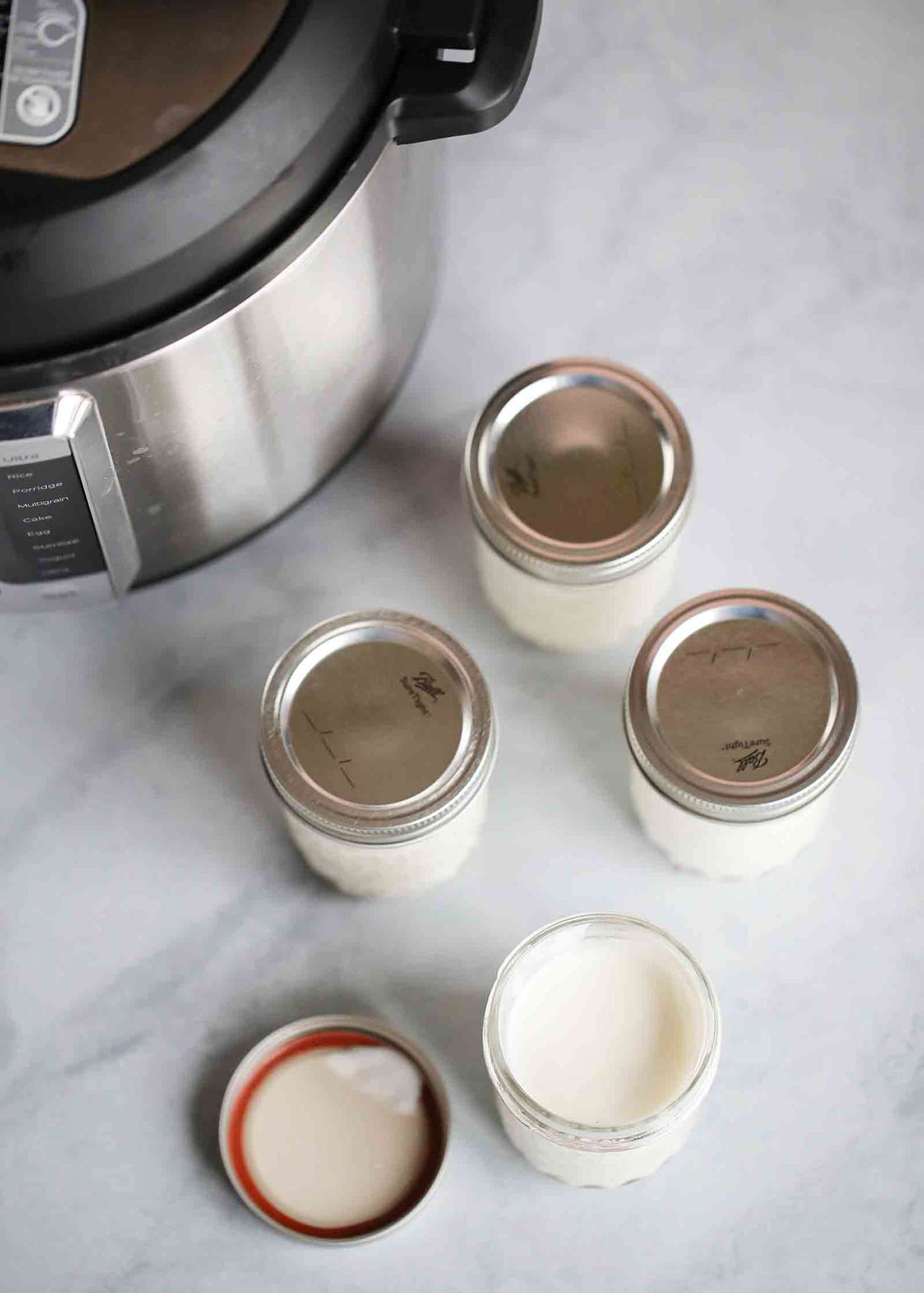 Overhead of four jars of homemade Instant Pot yogurt