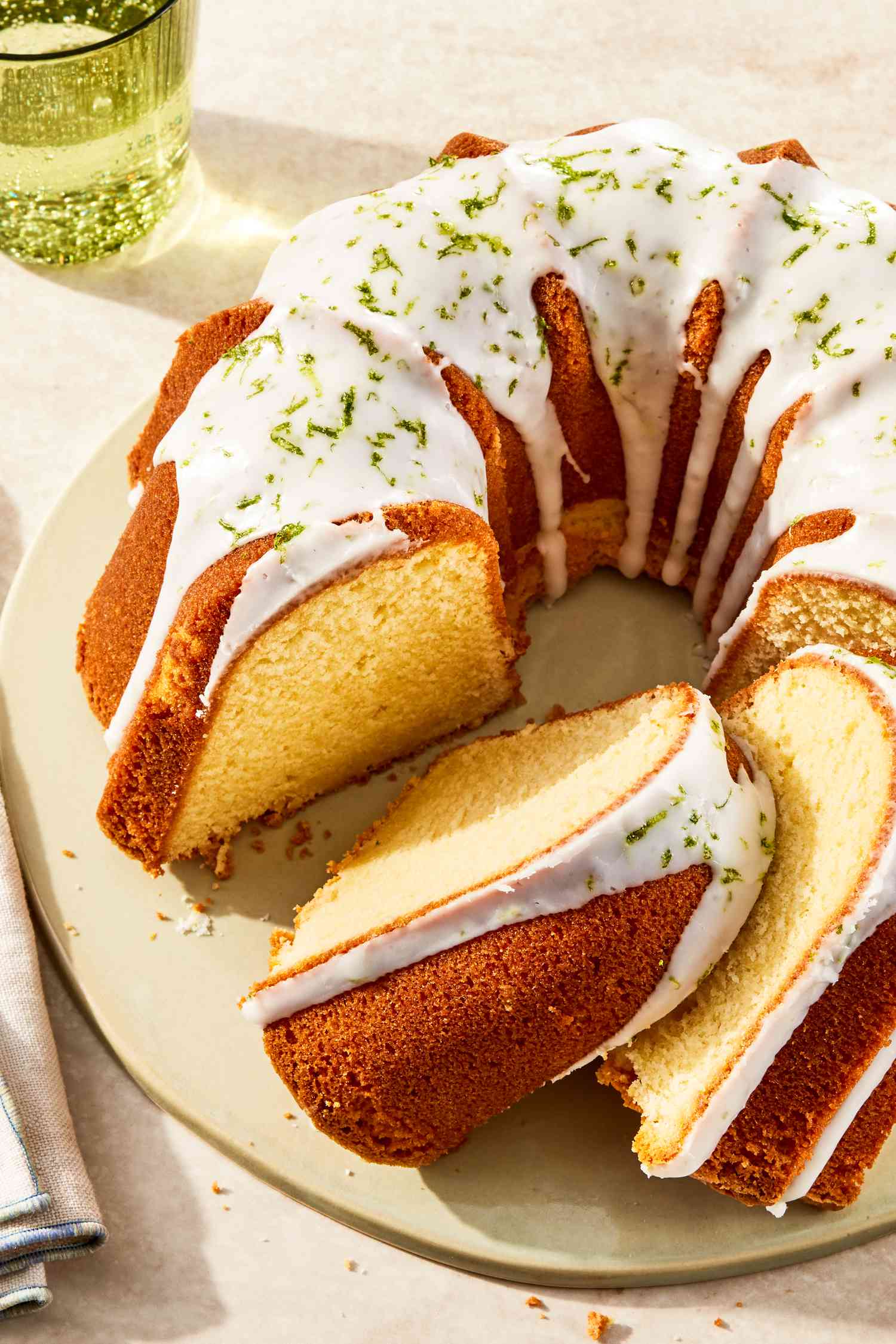 7UP bundt cake (with some slices) on a plate at a table setting