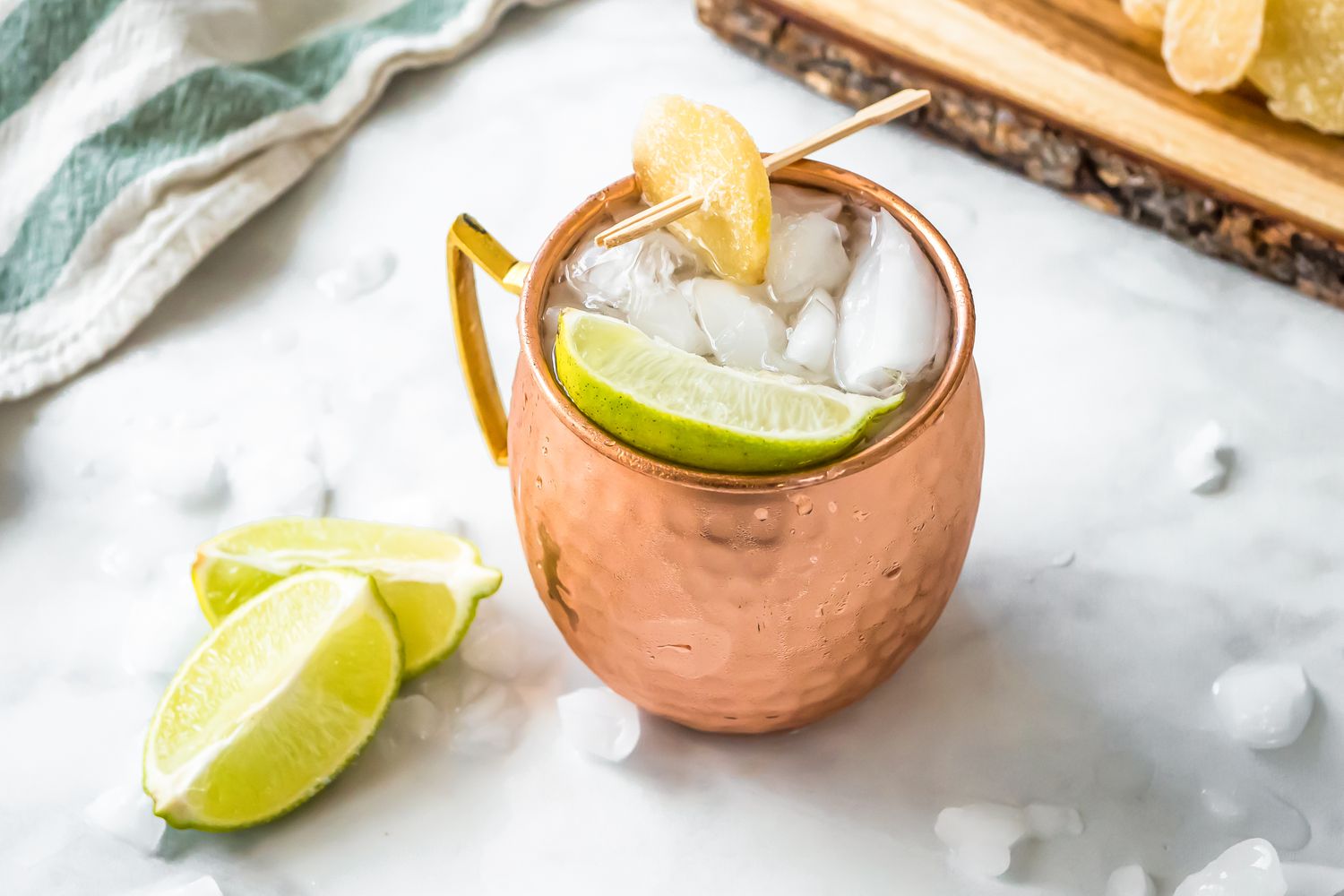 Mezcal Mule in a Copper Mug, Garnished with Candied Ginger and Lime. 