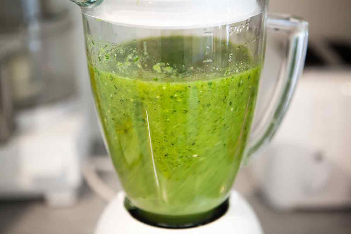 Salsa verde ingredients being blended in a blender