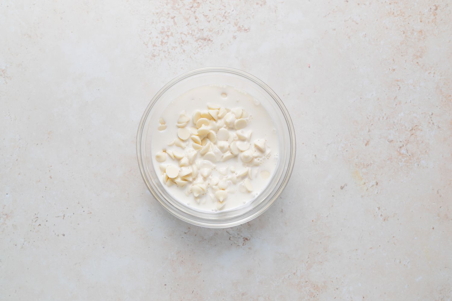 Making ganache in a small bowl for French macarons with peppermint white chocolate filling.