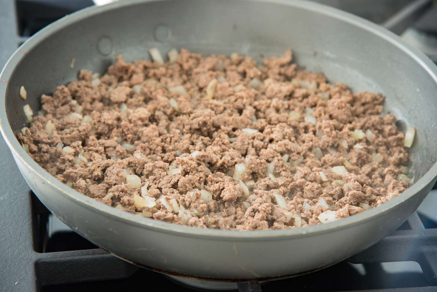 Cooked Ground Beef and Onions in a Skillet for Cheeseburger Pizza Recipe