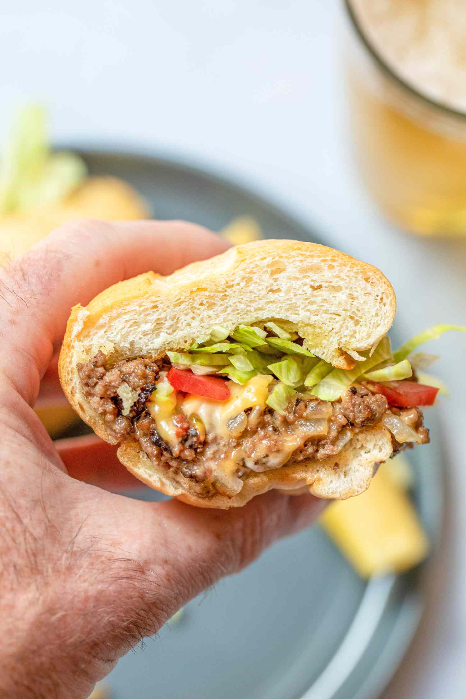 Hand Holding Chopped Cheese Halve