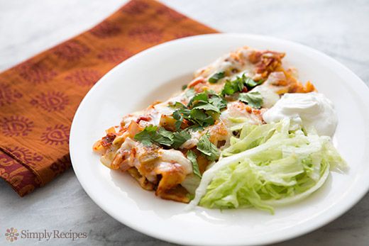 plated enchiladas with lettuce and sour cream