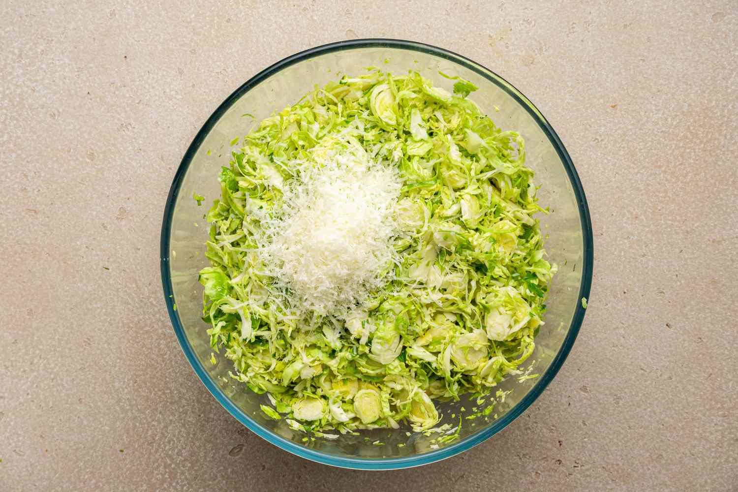 Parmesan Added to Bowl of Brussels Sprouts Caesar Salad Recipe 