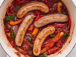 A pot of cooked Italian sausage, peppers, and onions