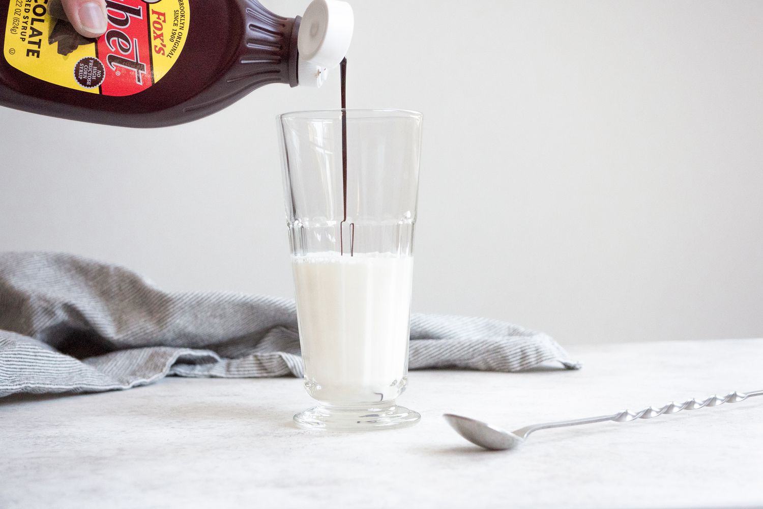 Chocolate Sauce Added to Glass of Milk for Egg Cream
