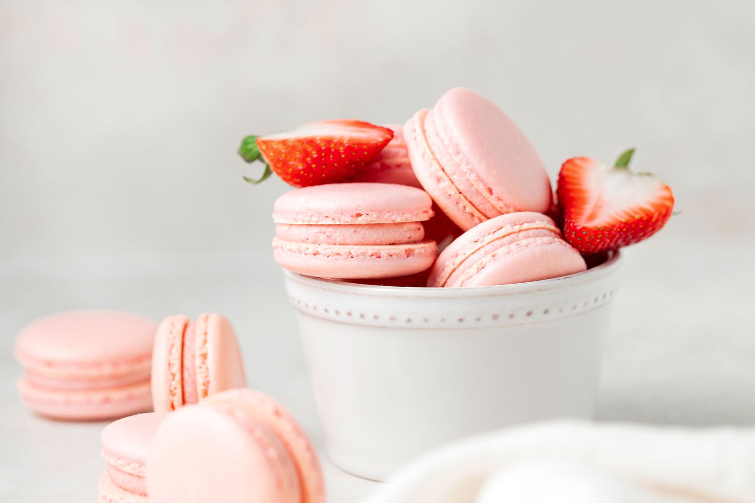Sweet and delightful strawberry macarons set in a small bowl