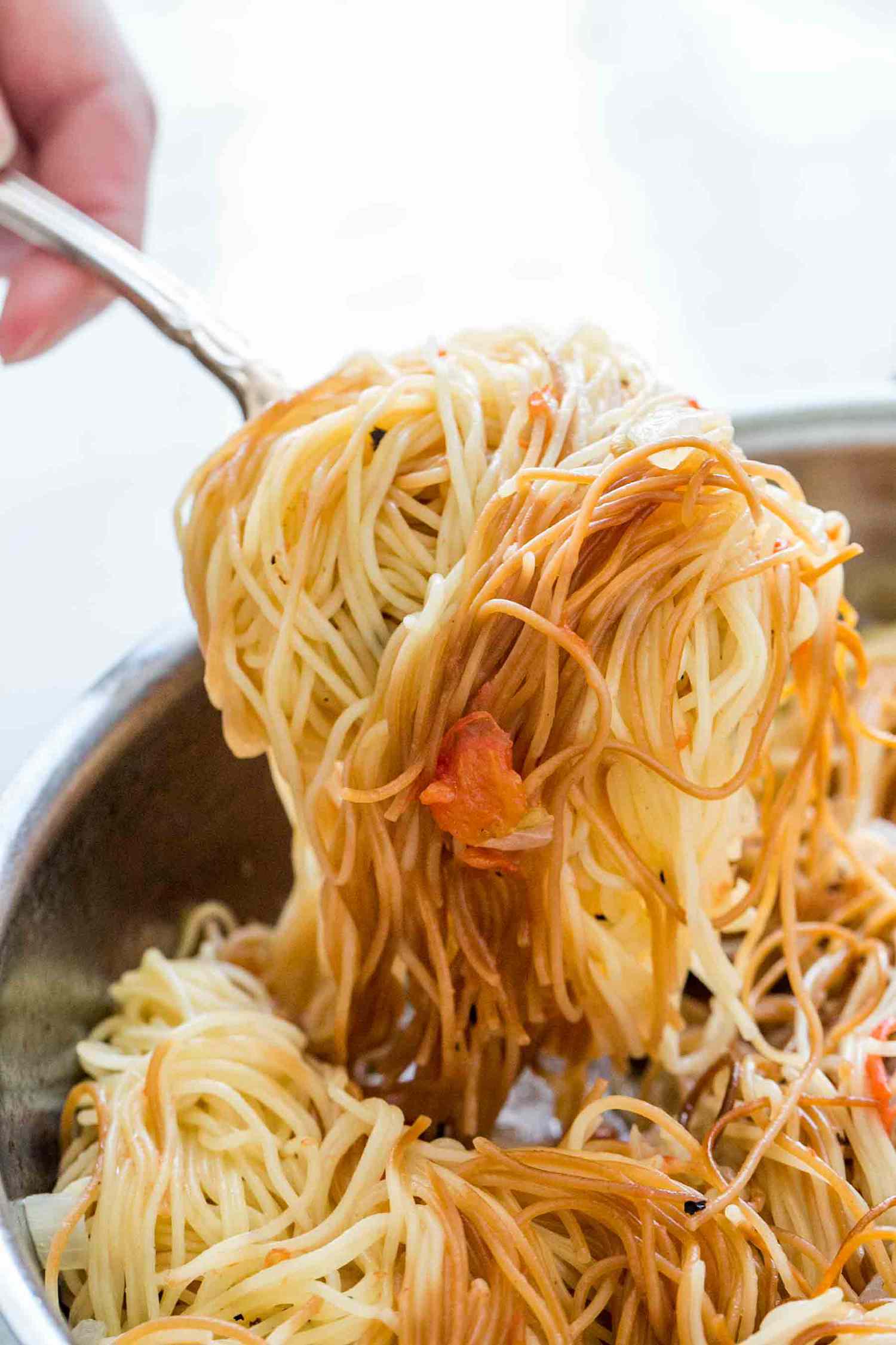 Sopa seca de fideo, angel hair nest pasta, first browned in olive oil, then cooked in a broth with tomatoes and onions.